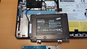 The SSD with strips and SATA cable attached, ready to be screwed into place.